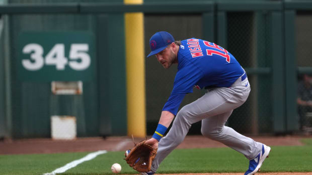 Mar 11, 2023; Phoenix, Arizona, USA; Chicago Cubs third baseman Patrick Wisdom (16) fields a ground ball against the Los Angeles Dodgers during the second inning at Camelback Ranch-Glendale. Mandatory Credit: Joe Camporeale-USA TODAY Sports